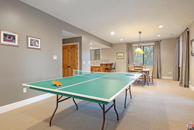 rec room featuring bar area, light carpet, baseboards, and recessed lighting
