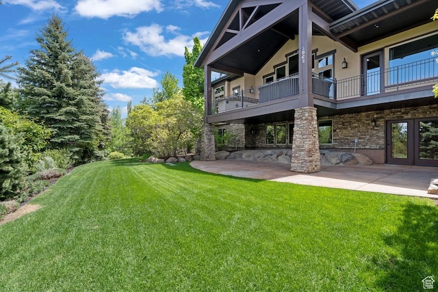 1562 E Granite Brook Ct S, Draper, UT 84020 - view of green lawn with a patio area, a balcony, and french doors
