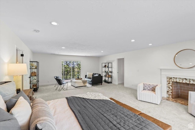 bedroom featuring a fireplace, light colored carpet, baseboards, and recessed lighting