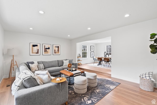 living area with wood finished floors and recessed lighting