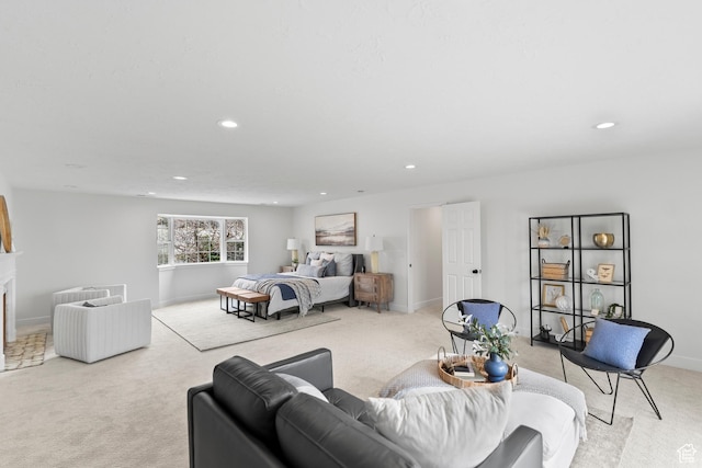 bedroom with a fireplace, recessed lighting, and light colored carpet