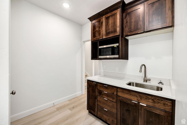 538 N 550 W, Smithfield, UT 84335 - kitchen with a sink, light wood-type flooring, stainless steel microwave, baseboards, and dark brown cabinets