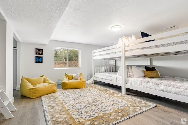 2233 S Beachcomber Ln, Garden City, UT 84028 - bedroom with wood finished floors and a textured ceiling