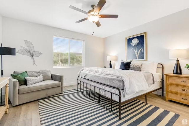 2233 S Beachcomber Ln, Garden City, UT 84028 - bedroom featuring baseboards, light wood-style floors, and a ceiling fan