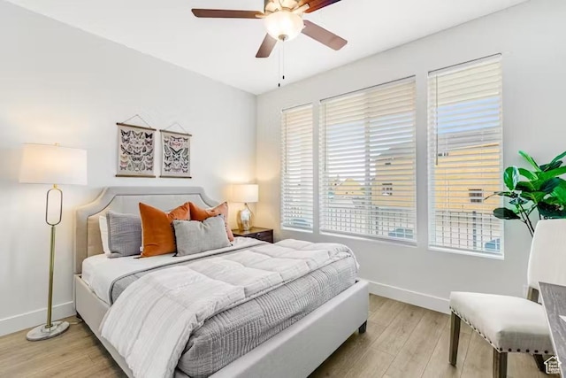 2233 S Beachcomber Ln, Garden City, UT 84028 - bedroom featuring a ceiling fan, baseboards, and light wood-style floors