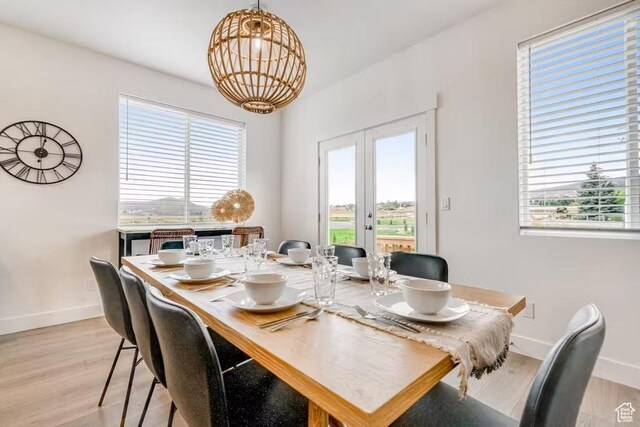 2233 S Beachcomber Ln, Garden City, UT 84028 - dining area with french doors, baseboards, light wood-style floors, and a wealth of natural light