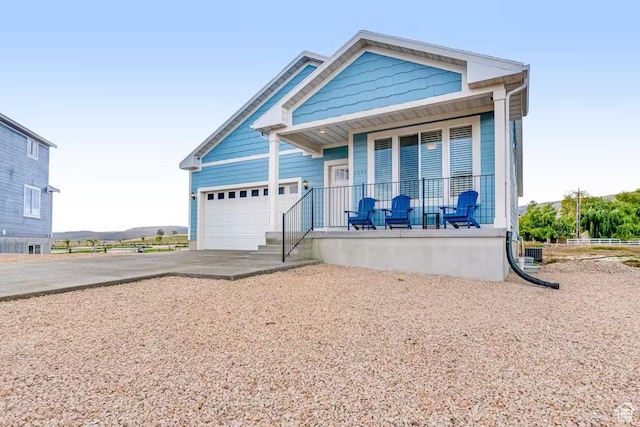 2233 S Beachcomber Ln, Garden City, UT 84028 - view of front facade featuring a porch, driveway, and a garage