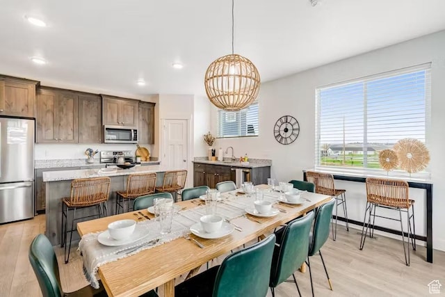 2233 S Beachcomber Ln, Garden City, UT 84028 - dining room with light wood-style flooring, an inviting chandelier, and recessed lighting
