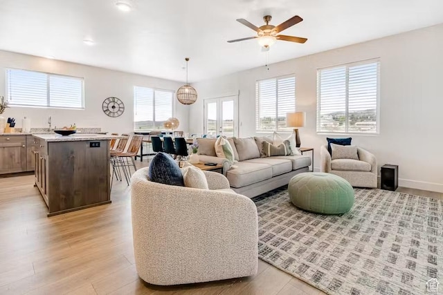 2233 S Beachcomber Ln, Garden City, UT 84028 - living area featuring baseboards, light wood-style flooring, and a ceiling fan