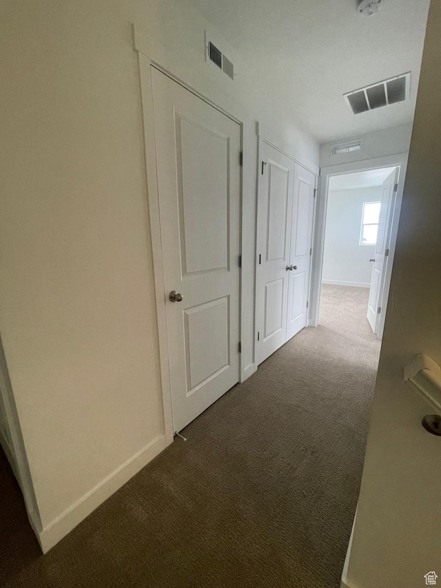 7164 W Iron Spring Ln S, West Jordan, UT 84081 - hall featuring baseboards, dark carpet, and visible vents