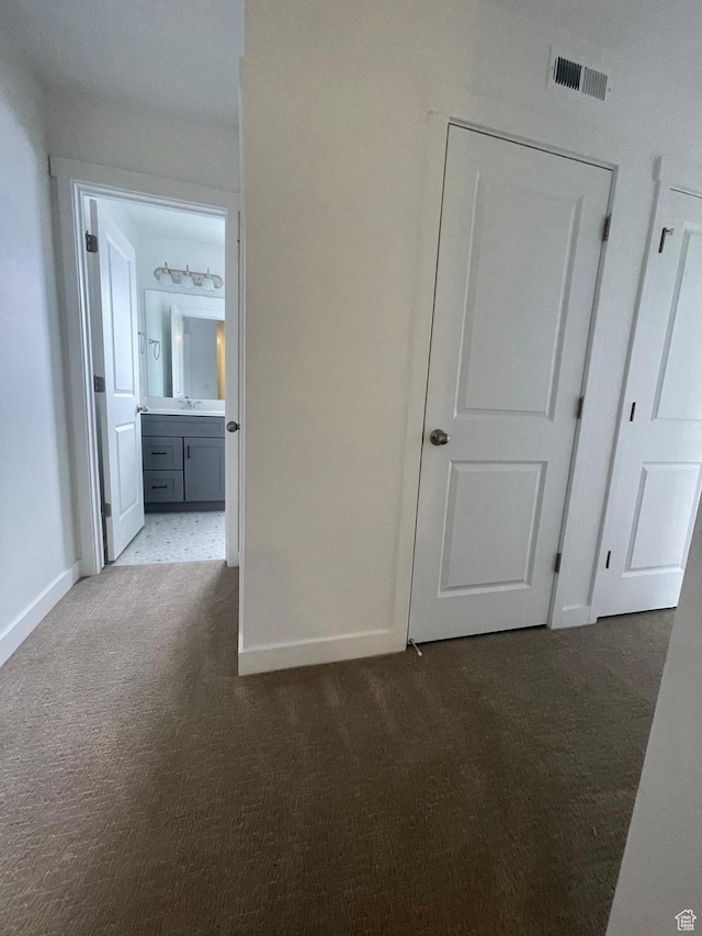 7164 W Iron Spring Ln S, West Jordan, UT 84081 - hallway featuring baseboards, carpet flooring, visible vents, and a sink