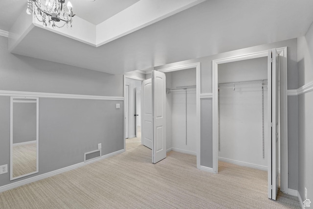 5025 N Shady Bend Ln, Lehi, UT 84043 - unfurnished bedroom featuring multiple closets, carpet floors, a chandelier, and baseboards