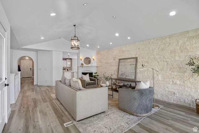 5025 N Shady Bend Ln, Lehi, UT 84043 - living room featuring arched walkways, vaulted ceiling, light wood finished floors, a chandelier, and recessed lighting