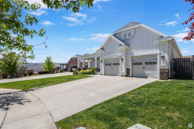 5025 N Shady Bend Ln, Lehi, UT 84043 - view of front of property with board and batten siding, concrete driveway, an attached garage, and stone siding