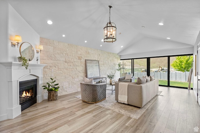 5025 N Shady Bend Ln, Lehi, UT 84043 - living area featuring a glass covered fireplace, wood finished floors, a chandelier, recessed lighting, and high vaulted ceiling