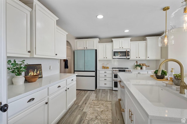 5025 N Shady Bend Ln, Lehi, UT 84043 - kitchen featuring refrigerator, range with two ovens, a sink, white cabinetry, and light wood-type flooring