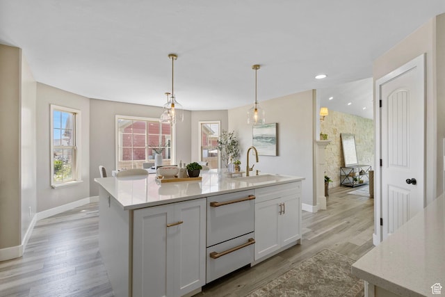 5025 N Shady Bend Ln, Lehi, UT 84043 - kitchen with a sink, baseboards, an island with sink, white cabinetry, and light wood finished floors