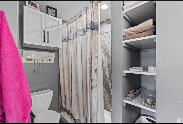 full bathroom featuring toilet and curtained shower