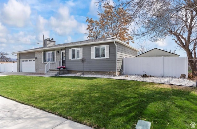 ranch-style home featuring fence, a chimney, a garage, a front yard, and driveway
