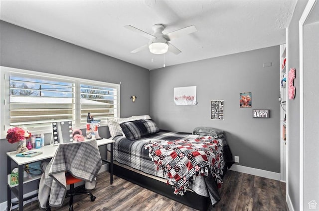 bedroom featuring baseboards, ceiling fan, and wood finished floors