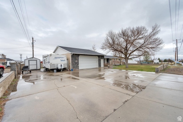 6102 W 13400 S, Herriman, UT 84096 - view of side of home with stone siding, fence, a storage shed, a garage, and driveway