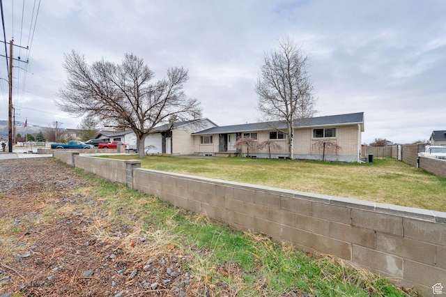 6102 W 13400 S, Herriman, UT 84096 - view of front of house with a front lawn, fence, and brick siding