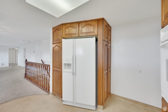 6102 W 13400 S, Herriman, UT 84096 - kitchen with lofted ceiling, brown cabinets, light colored carpet, and white appliances