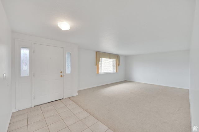 6102 W 13400 S, Herriman, UT 84096 - entrance foyer featuring baseboards, light tile patterned floors, and light colored carpet