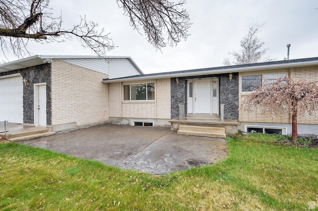 6102 W 13400 S, Herriman, UT 84096 - view of front of home with a front yard, an attached garage, brick siding, and a patio