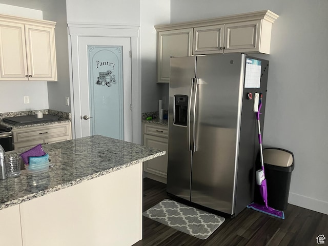 285 W 1580 N Unit 102, Logan, UT 84341 - kitchen featuring stainless steel fridge with ice dispenser, cream cabinets, light stone counters, and dark wood finished floors