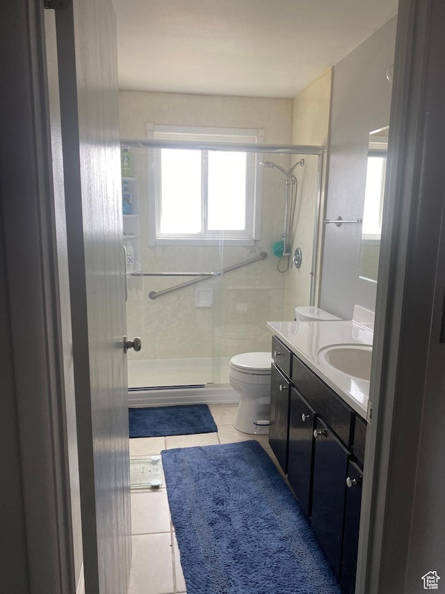 6489 W Castle View Dr S, West Valley City, UT 84128 - bathroom featuring a stall shower, toilet, tile patterned flooring, and vanity