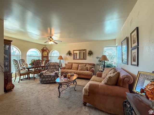carpeted living room with a ceiling fan and plenty of natural light
