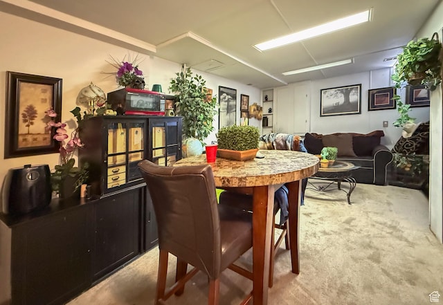 dining space with light colored carpet