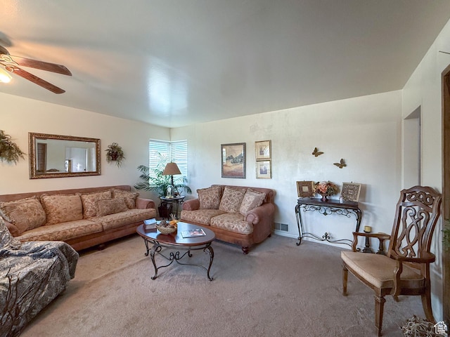 carpeted living room with visible vents and a ceiling fan