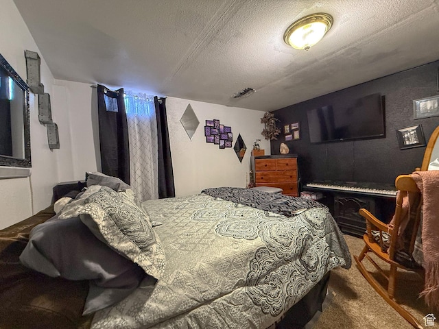 bedroom with carpet floors and a textured ceiling
