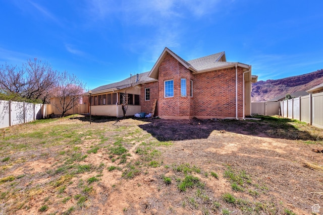 494 E Kachina Way, Moab, UT 84532 - rear view of property featuring a fenced backyard and brick siding