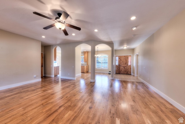 494 E Kachina Way, Moab, UT 84532 - unfurnished living room featuring recessed lighting, baseboards, arched walkways, light wood-style floors, and ceiling fan