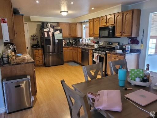 805 N Valley View Dr W, Castle Dale, UT 84513 - kitchen featuring a healthy amount of sunlight, brown cabinets, stainless steel appliances, and light wood finished floors