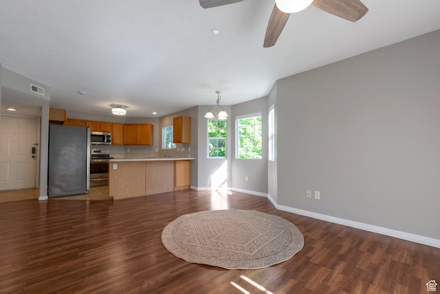 1476 W Brunello Dr S Unit C-5, Bluffdale, UT 84065 - kitchen with appliances with stainless steel finishes, open floor plan, light countertops, dark wood-style floors, and a chandelier