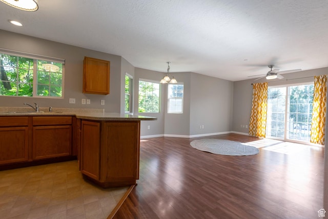 1476 W Brunello Dr S Unit C-5, Bluffdale, UT 84065 - kitchen with plenty of natural light, brown cabinets, and a chandelier
