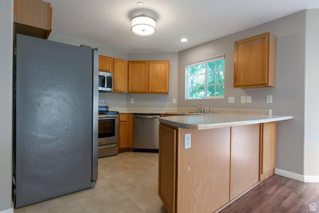 1476 W Brunello Dr S Unit C-5, Bluffdale, UT 84065 - kitchen with stainless steel appliances, a peninsula, light countertops, and light floors