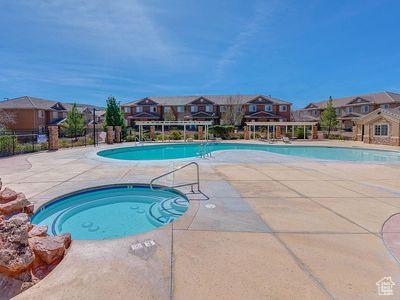 3155 S Hidden Valley Dr Unit 331, St George, UT 84790 - community pool featuring a community hot tub, a patio area, fence, and a residential view