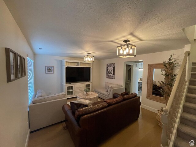 3155 S Hidden Valley Dr Unit 331, St George, UT 84790 - living area featuring stairs, baseboards, a textured ceiling, a notable chandelier, and wood finished floors