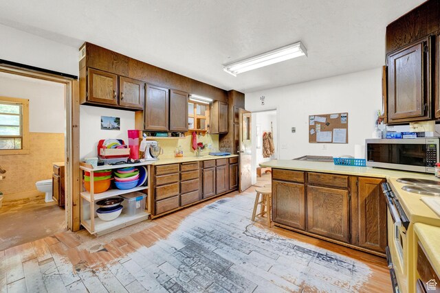 477 N 300 W, Brigham City, UT 84302 - kitchen with electric stove, light countertops, light wood-style floors, and stainless steel microwave