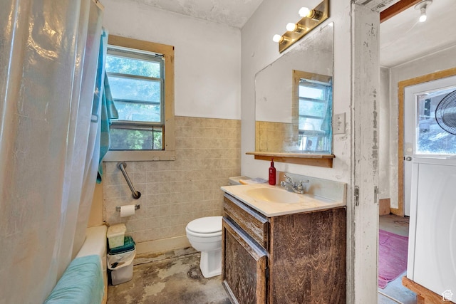 477 N 300 W, Brigham City, UT 84302 - full bathroom featuring a wainscoted wall, toilet, vanity, shower / bathtub combination with curtain, and tile walls