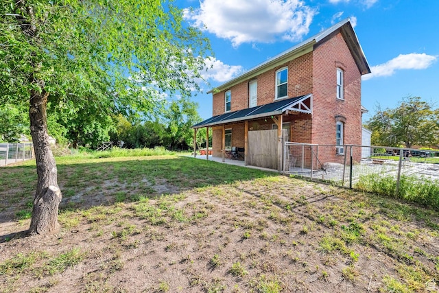 477 N 300 W, Brigham City, UT 84302 - rear view of house with brick siding, a lawn, fence, and a patio