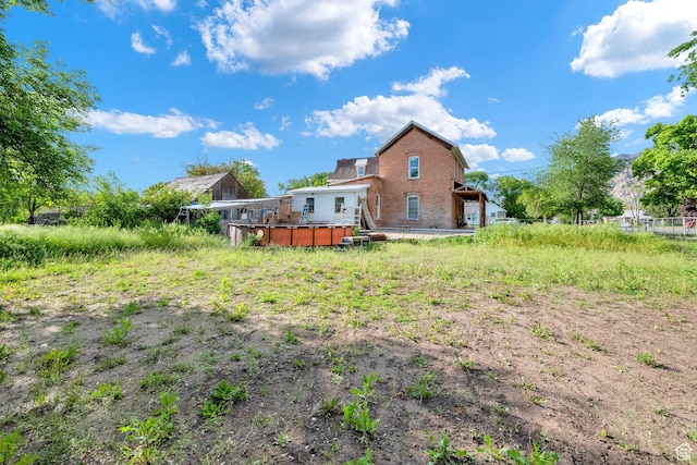 477 N 300 W, Brigham City, UT 84302 - rear view of house with brick siding and a deck