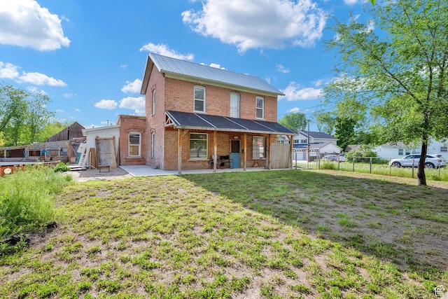 477 N 300 W, Brigham City, UT 84302 - rear view of property featuring fence, a patio, metal roof, brick siding, and a yard