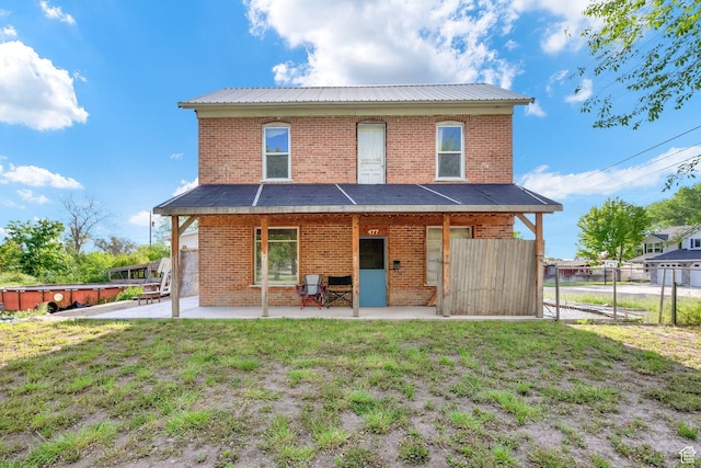 477 N 300 W, Brigham City, UT 84302 - rear view of house with a yard, brick siding, fence, and metal roof