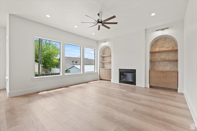 1065 W 125 S, Lehi, UT 84043 - unfurnished living room featuring a ceiling fan, a glass covered fireplace, light wood-type flooring, baseboards, and recessed lighting
